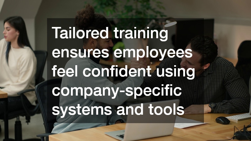 manager providing training to an employee, with a laptop open on the desk